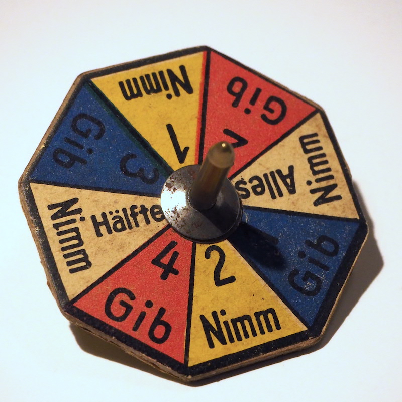 8-Seitiger Nimm-Gib-Kreisel aus Pappe mit Metalspitze
